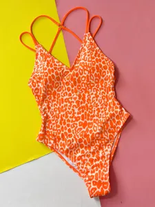 Sexy orange and white leopard print one-piece swimsuit with V-neck and cross-back straps.
