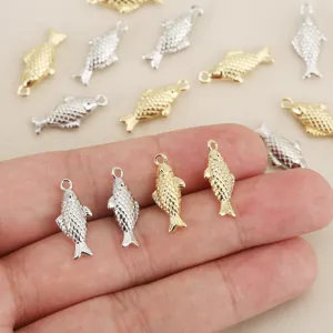Detail view of metallic 3d fish charms, gold and silver koi pendants for diy jewelry crafts.