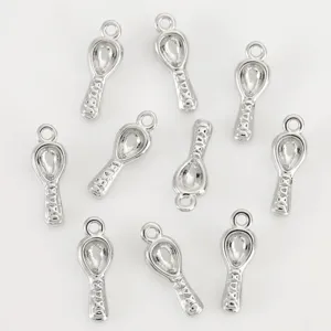Detailed shot of silver spoon pendants, mini DIY jewelry charms, polished metal accessories.