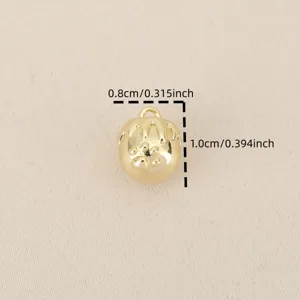 Close-up detail of a mini 18k gold plated strawberry pendant charm with paw print.