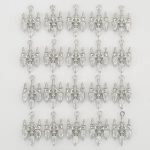 Close-up detail of silver chandelier pendant charms with sparkling cubic zirconia stones.