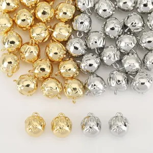 Detailed view of gold and silver 3D strawberry metal pendants for DIY jewelry crafting.
