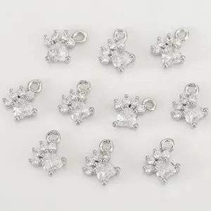 Close-up view of silver-plated paw charms inlaid with clear zircon for DIY jewelry.
