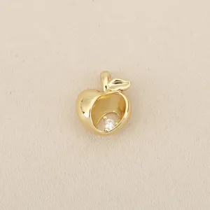 Close-up detail of a gold plated apple pendant with sparkling crystal zircon inlay DIY charm.