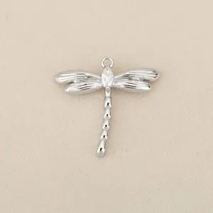 Detailed close-up view of a silver plated metal dragonfly pendant with sparkling zircon stone.
