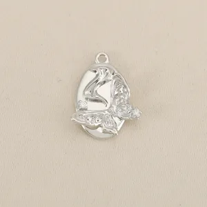 Detailed shot of silver plated butterfly pendant with sparkling cubic zirconia DIY jewelry.