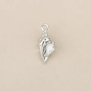 Close-up detail of a silver-toned conch shell pendant inlaid with sparkling cubic zirconia.