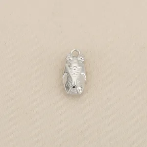 Detailed close-up of a silver-toned cicada metal charm, ideal for creative DIY jewelry making.