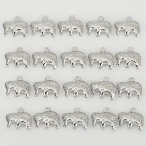 Detail view of silver-colored elephant charms featuring intricate swirl patterns for DIY crafts.