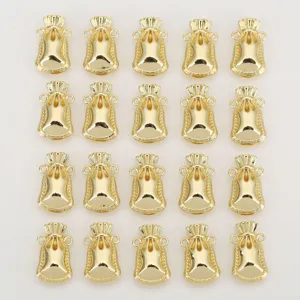 Gold lucky bag charm detail, miniature metal lucky pendant for DIY jewelry making.