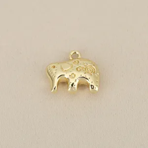 Detail shot of a gold-plated elephant pendant with intricate auspicious texture for DIY jewelry.