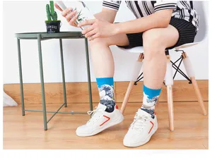 Detailed shot of men's mid-calf vintage oil painting socks paired with white sneakers.