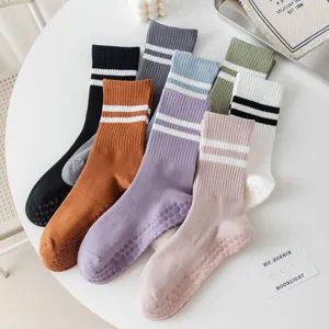 Non-slip cotton yoga socks detail with grip dots and stripes, perfect for pilates.