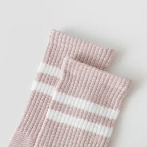 Close-up detail of pink and white striped cotton crew socks, soft ribbed knit texture.
