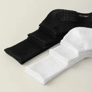 Detailed view of black and white cotton long athletic tube socks for men and daily sportswear.