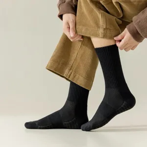 Black athletic crew socks for men with breathable mesh design and comfortable ribbed cuffs.