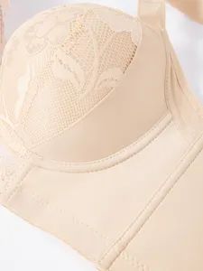Lace bra detail close-up, soft nude fabric, delicate floral pattern, comfortable fit.