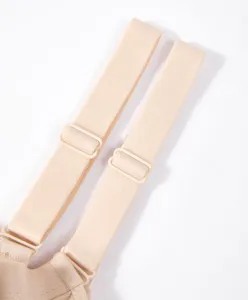 Close-up detail of nude bra adjustable straps and buckles for women undergarments.