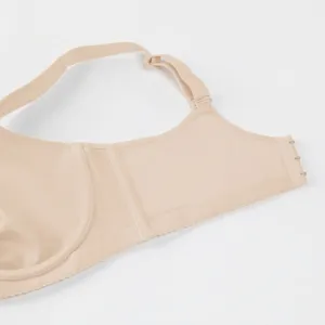Detail shot of a nude plus size seamless wireless supportive women bra side view
