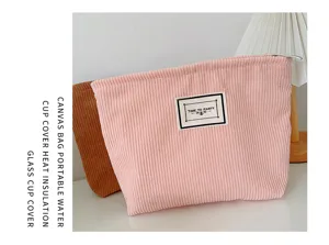 Corduroy cosmetic bag detailed view, soft texture, portable zipper makeup pouch for travel.