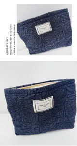 Detailed view of dark blue vintage rose jacquard cosmetic bag, portable travel pouch organizer.