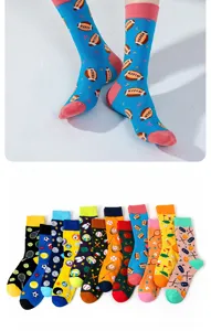 Detail view of colorful fashion sports crew socks featuring various ball patterns like football and tennis.