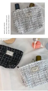 Detailed view of the elegant tweed cosmetic bag, featuring stylish bouclé fabric and compact design.