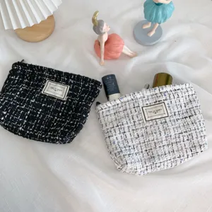 Tweed cosmetic bag for women, stylish portable travel makeup pouch, large capacity organizer.