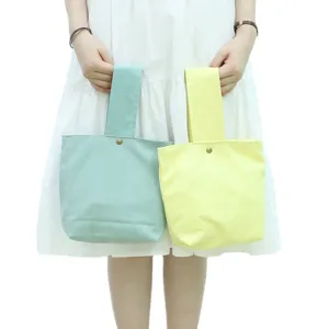 Minimalist solid color canvas tote bag cute wrist handbag for women daily casual shopping.