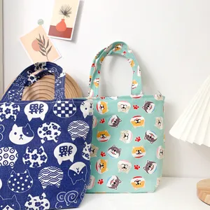 Detail view of cute canvas lunch bag with lovely cat and dog print, portable daily tote.