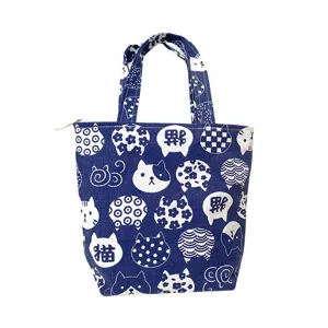 Blue canvas lunch bag with cute cat patterns, portable handbag with zipper closure.