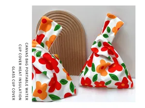 Detailed view of Japanese style floral canvas knot bag and cup cover with red print.
