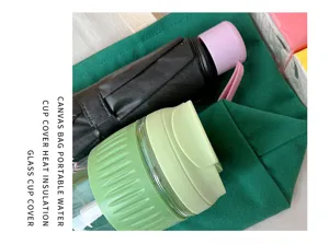 Green canvas bento bag detail shot showcasing portable glass cup and daily travel accessories