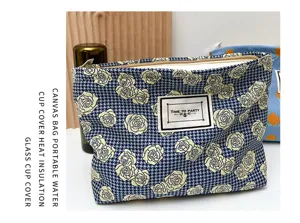 Portable canvas cosmetic bag with trendy houndstooth rose floral pattern and secure zipper closure.