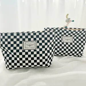 Classic black and white checkerboard cosmetic bag, stylish canvas portable storage pouch.
