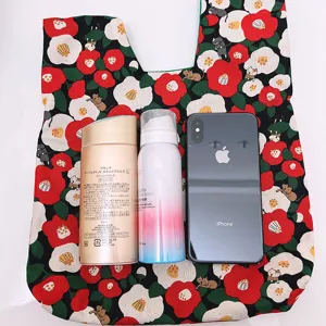 Japanese style floral knot fabric handbag detail, camellia and cat print wrist bag.