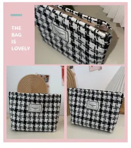 Black and white houndstooth tweed makeup pouch, stylish zipper cosmetic bag for daily use.