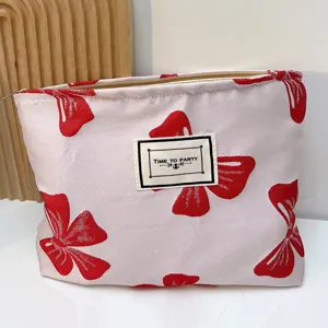 Tragbare Kosmetiktasche mit rotem Schleifenprint, stilvoller Canvas Make-up Beutel für Damen.