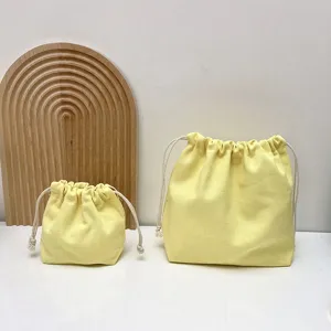 Leinwand Kordelzug Make-up Aufbewahrung Tasche Detail, gelbe Kosmetiktasche für den Alltag.