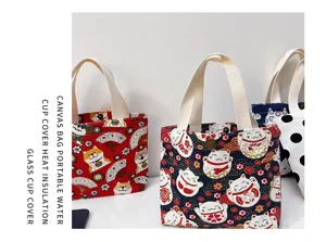 Close-up detail of Japanese style cartoon print canvas mini handbag cup cover with strap.
