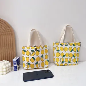 Bolso de mano de lona con bonito estampado de limón para mujer, bolso pequeño práctico.