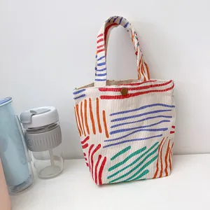 Bunte gestreifte Kord-Tragetasche, kleine lässige Pendler-Handtasche und Bento-Aufbewahrung.