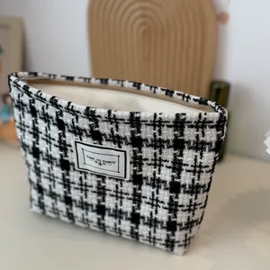 Black and white tweed plaid cosmetic bag for women, large capacity stylish makeup pouch.