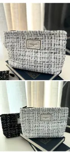 Large capacity tweed cosmetic bag with zipper, stylish portable makeup pouch for women daily use.
