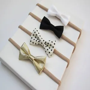 Close-up detail of cute infant bow headbands, elastic soft nylon bands in assorted colors and patterns.