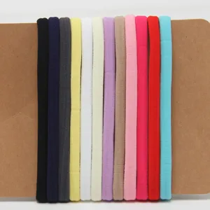 Close-up detail shot of colorful baby nylon elastic headbands neatly displayed on backing card.