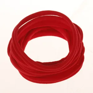 Close-up detail of soft red elastic nylon hair bands stacked in a neat circle, perfect for DIY.