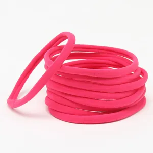 Detailed view of hot pink seamless nylon elastic hair bands, soft DIY baby headband accessories.