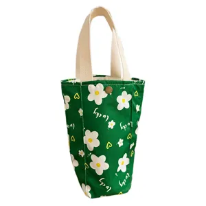 Portable canvas green water bottle bag with cute white flower prints and sturdy handles main view