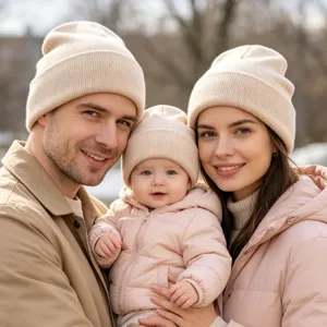 Detail view of cozy matching knit beanies worn by family outdoors in cold winter weather.